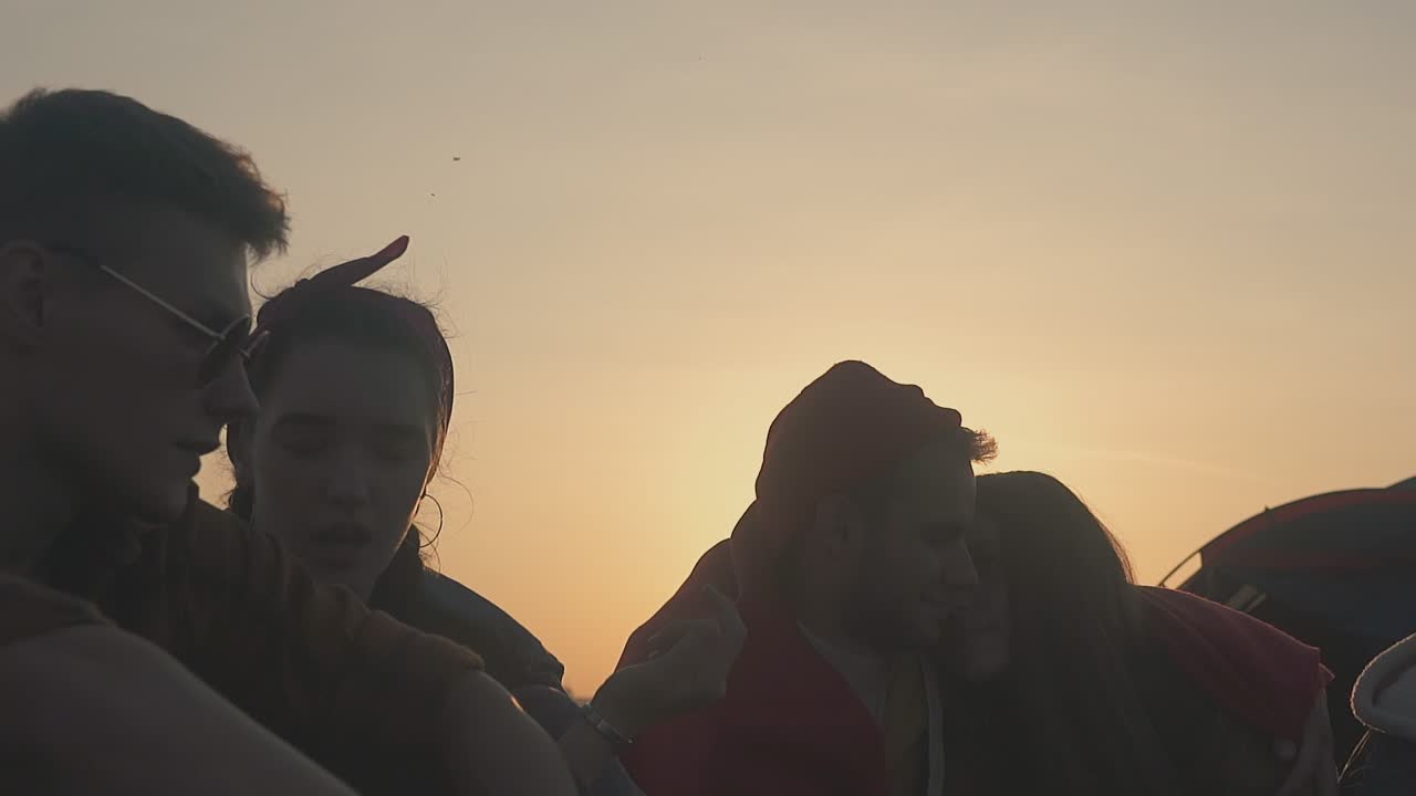 happy couple rests with friends in tourist camp slow motion