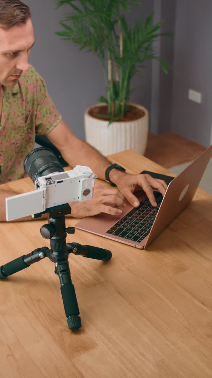 Person Vlogging with Camera and Laptop
