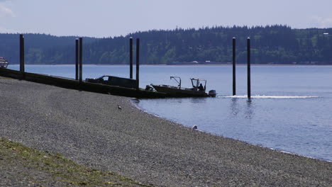 small, nondescript fishing loading onto trailer from public boat launch ramp at camano island state park, wa state