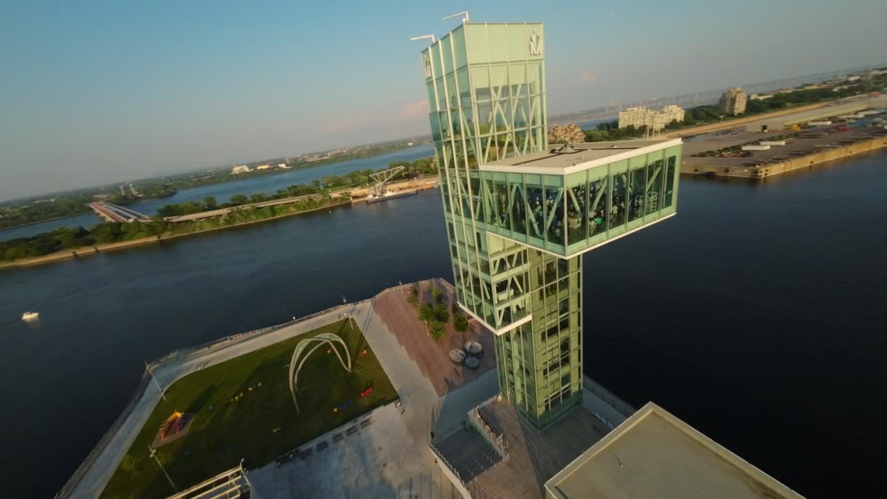 Aerial View of a Modern Glass Tower by the River