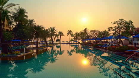 beautiful-palm-tree-with-umbrella-chair-pool-in-luxury-hotel-resort-at-sunrise-times