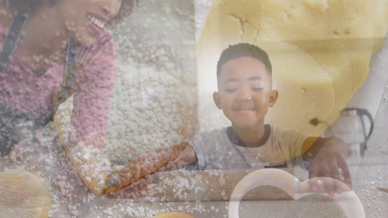 행복 한 아프리카계 미국인 어머니 와 아들 이 반죽 과 쿠키 를  ⁇ 고 있는 애니메이션