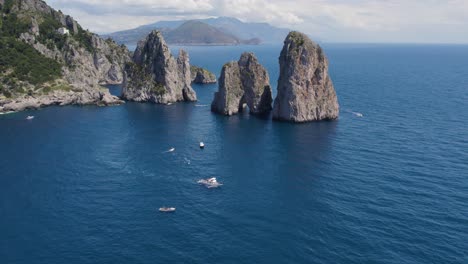 Aerial-of-the-Faraglioni-Sea-Stack-Rock-Formations-on-Capri-Coast,-Italy