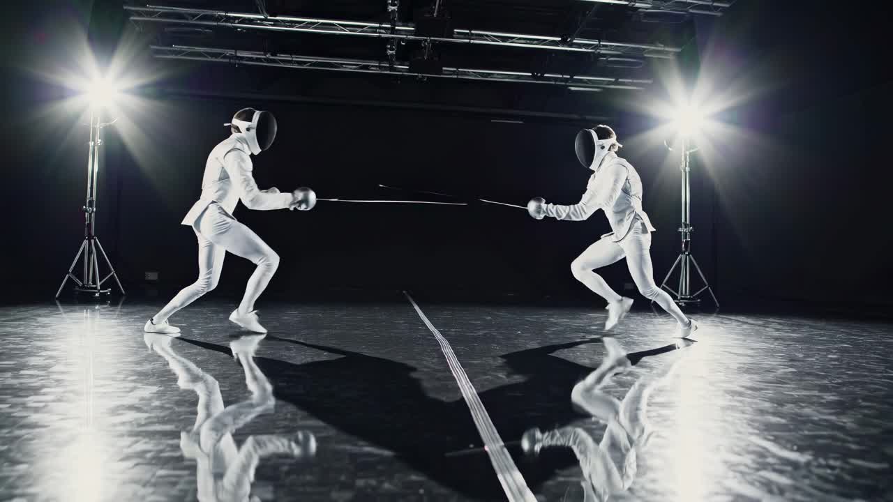 Dynamic video still of two fencers in action, captured from a low angle