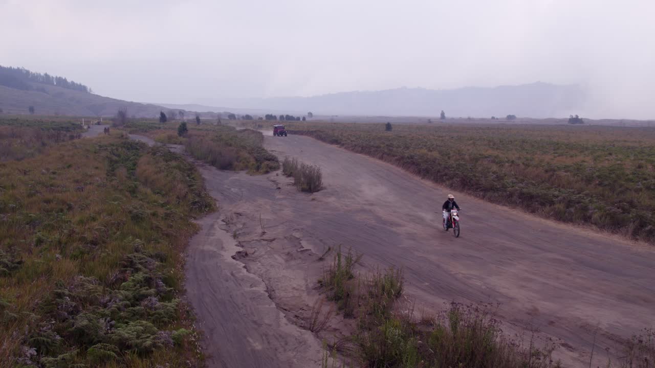 Moto e jeep nel terreno sabbioso del Bromo, Indonesia