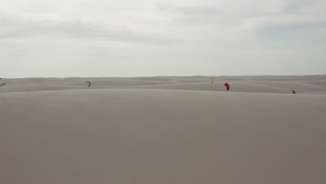 Aerial:-Kitesurfing-in-the-dunes-of-Lencois-Maranhenses,-Northern-Brazil