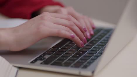 close up of caucasian woman typing on laptop computer, remote work