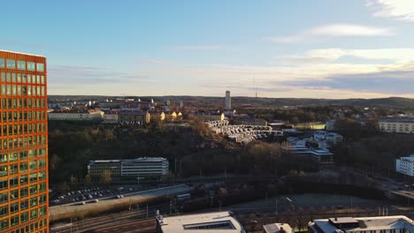 Drone-Passing-By-Garda-Vesta-Building-With-Water-Tower-In-The-Distance-In-Lunden,-Orgryte-Borough,-Gothenburg,-Sweden