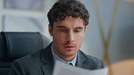 portrait corporate leader working alone examining documents. man read contract