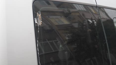 damaged car window with bird droppings