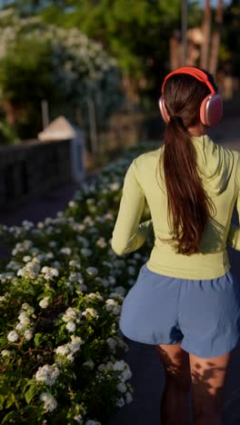 woman running outdoors with headphones