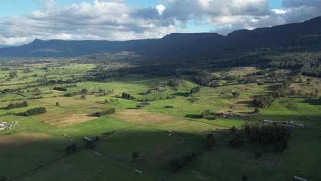 Aerial-wide-shot-of-green-magnificent-landscape-at-sunset-of-Tasmania-Island