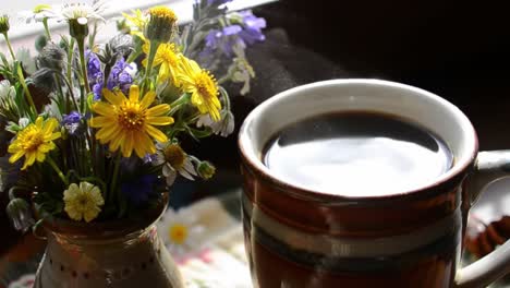 a cozy morning scene featuring a steaming cup of coffee next to a beautiful vase of colorful wildflowers, inviting warmth and comfort to start the day