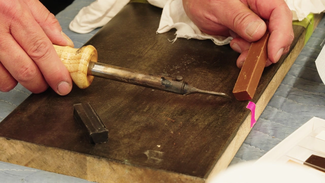 Complete repair process: hot knife melts burn-in stick, surface wiped with cloth