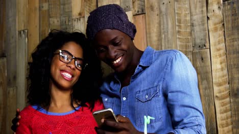 happy couple using mobile phone