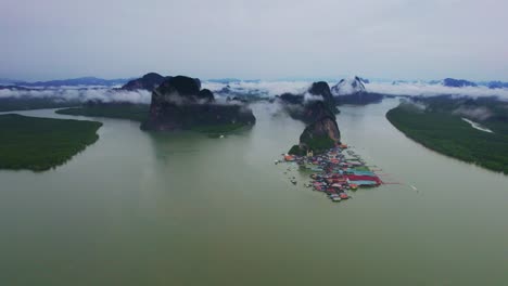 beautiful scenic aerial panoramic view overlooking the fishing village of koh panyee island with mangrove landscape and limestone cliffs in the background, phang nga bay, thailand