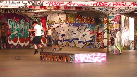 skateboarders performing tricks in urban skatepark