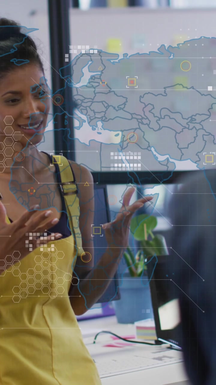 Animation of world map against african american woman talking to diverse colleagues at office