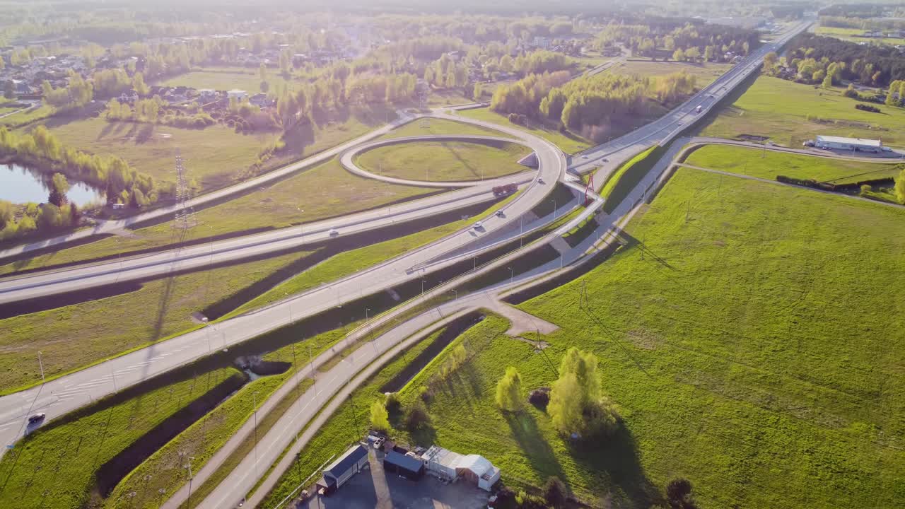 Beautiful endless highway road with green countryside on sunny day, aerial view