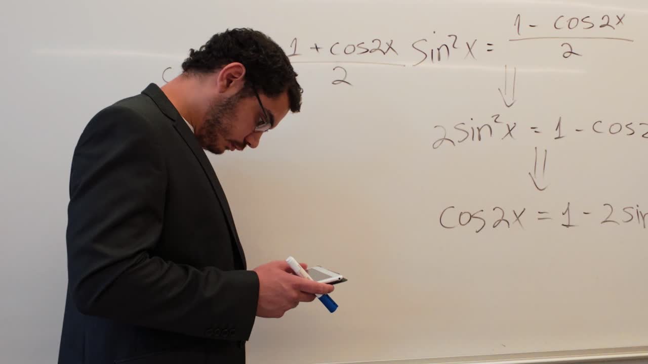 Modern Educator Using a Tablet While Teaching Math