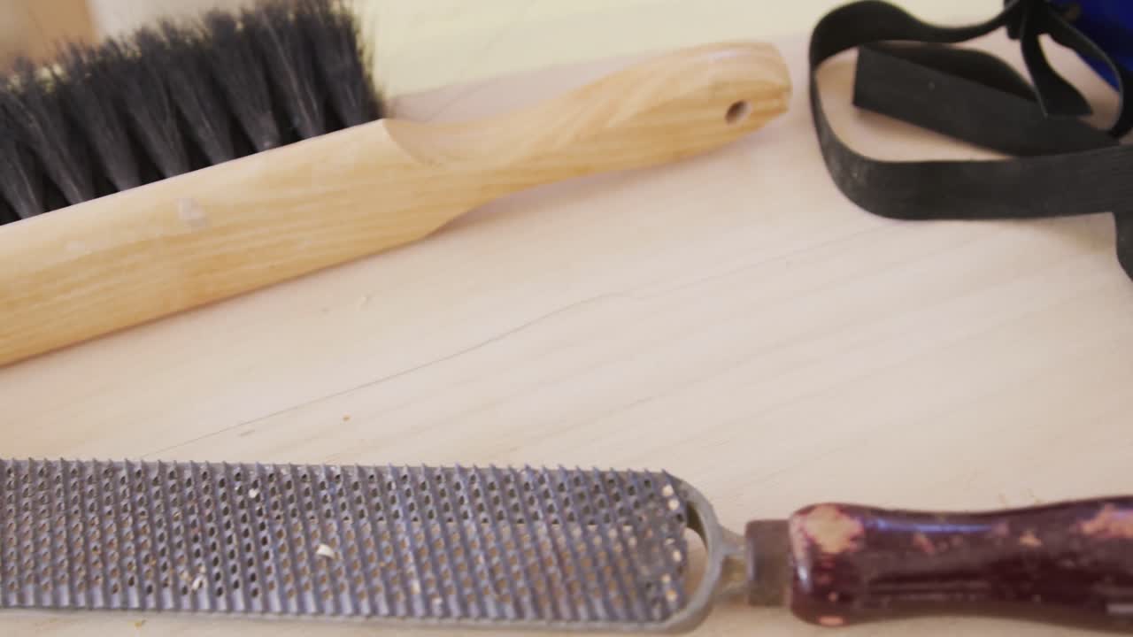 Close up of multiple surfboard maker tools on a table