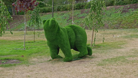 grass sculpture of a bear in a park