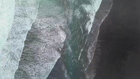 Moody-overhead-view-of-the-black-sand-and-surf-in-New-Zealand