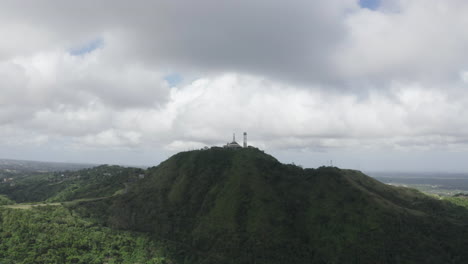 cinematic aerial footage of a tower on a rainforest hill close to cebu in the philippines, asia, drone