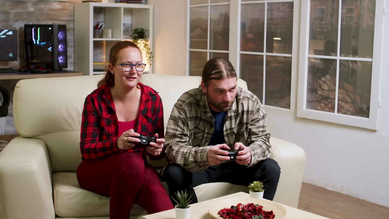 Couple playing video games on the couch