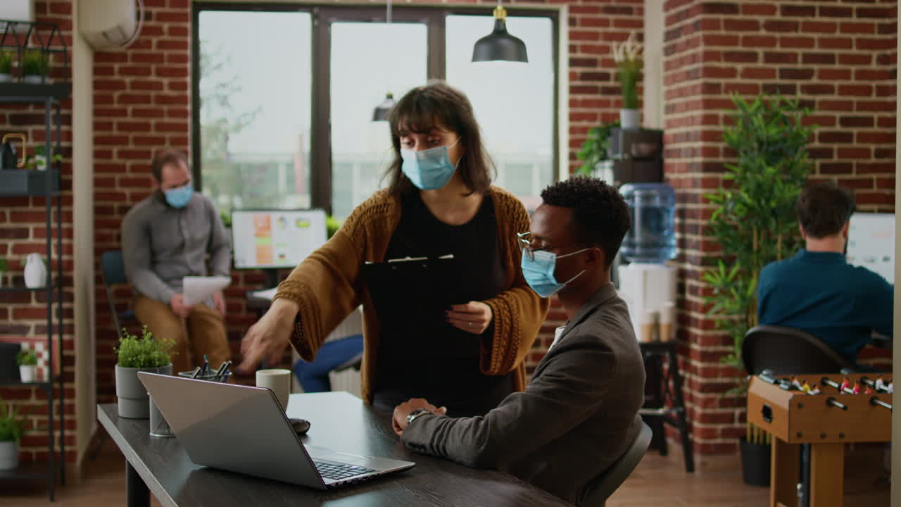 Diverse team of colleagues working on company data in office