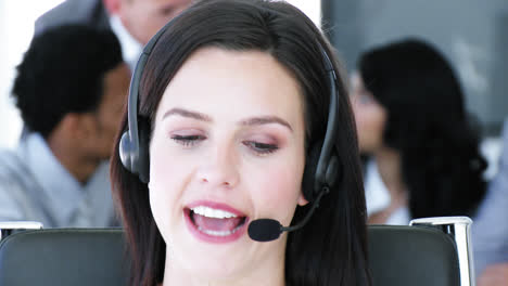 Portrait-of-businesswoman-talking-on-a-headset-in-a-call-center