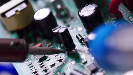 the engineer replaced the ic transistor with a soldering iron on the electrical circuit pcb board to fix device device