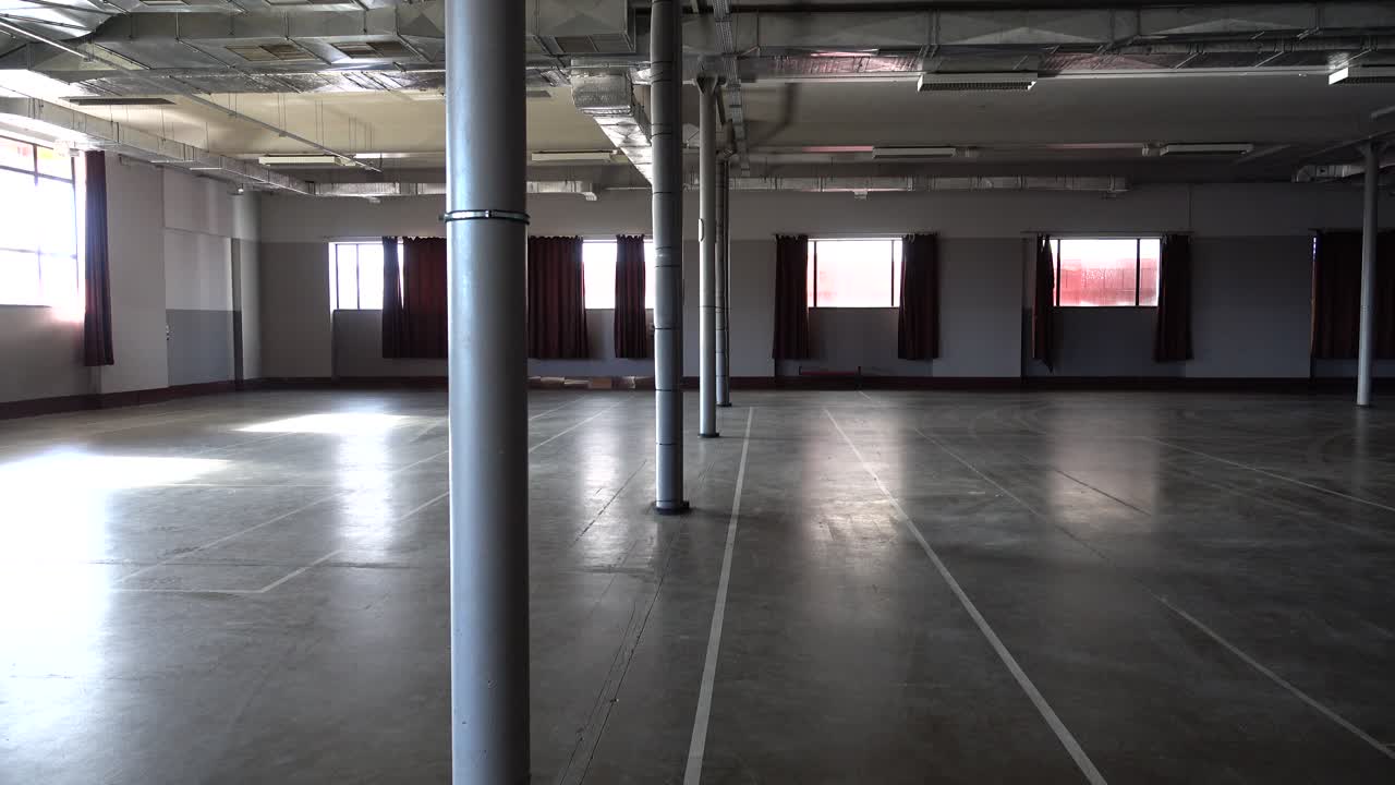 Spacious Empty Industrial Hall with Concrete Floor and Pillars
