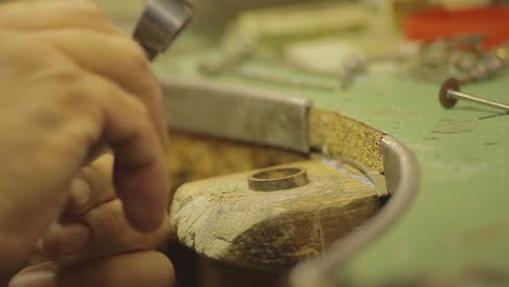 italian goldsmith at work building an engagement or a wedding ring