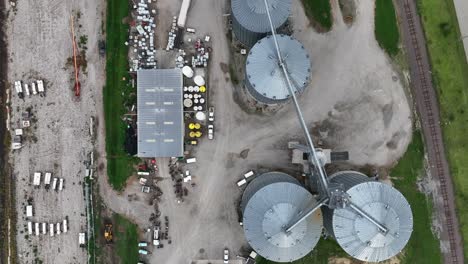 aerial view of industrial grain silos and storage facilities with adjacent railroad track