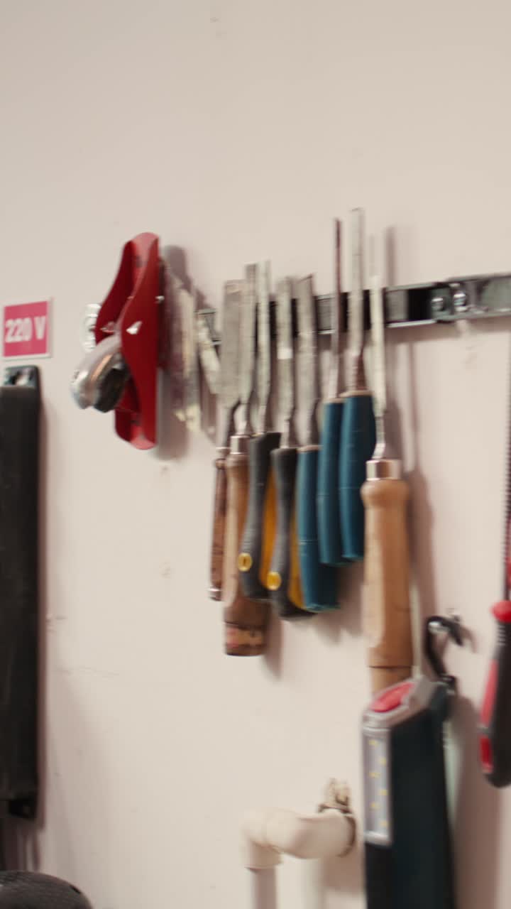 Various Hand Tools and Electrical Outlets Organized on a Workshop Wall