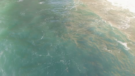 Aerial-flight-over-the-sea-discovering-white-chalk-cliffs-and-arches-at-Etretat