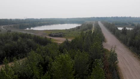 4K-Drone-Video-of-Discarded-Giant-Excavator-Tire-Pile-in-wilderness-near-Fairbanks,-AK-during-Summer-Day