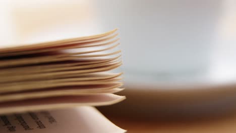 close-up of coffee cup with open book