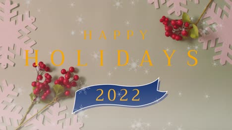 Animation-of-snow-falling-and-happy-holidays-2022-text-over-christmas-decorations