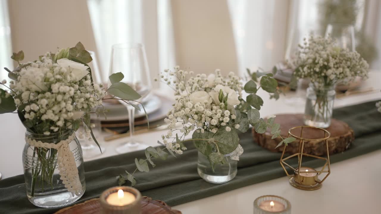 wedding table with white flowers wood slices and soft candle accents