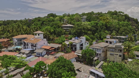 unawatuna sri lanka aerial v5 cinematic low drone flyover sandy beach capturing beachfront resorts and hillside hotels with beautiful ocean views in summer - shot with mavic 3 cine - april 2023