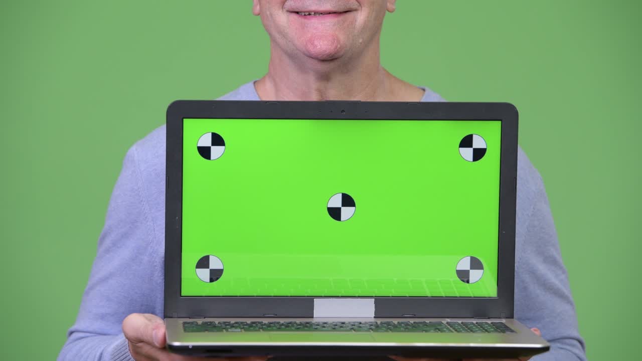 Senior handsome man showing laptop