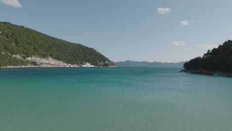 scenic aerial 5k drone over clear, turquoise, blue mediterranean sea at croatian prapratno beach