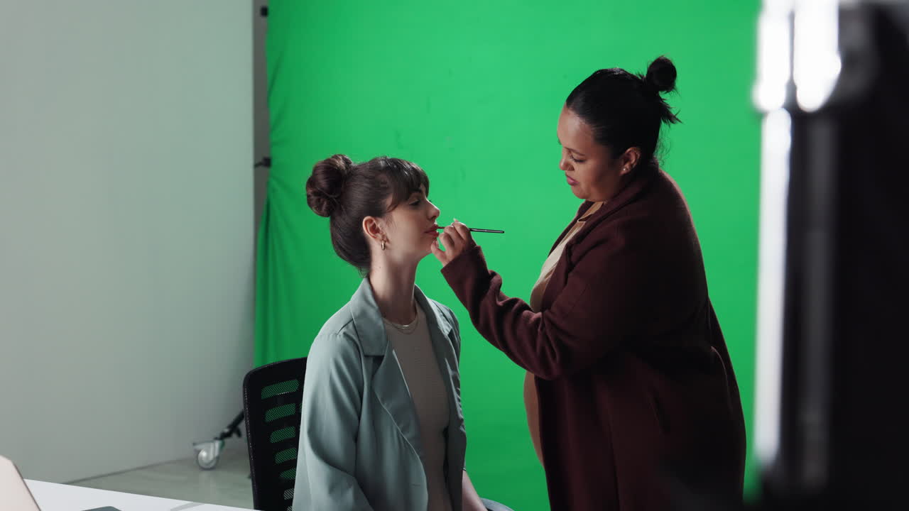 Woman sitting in studio with green screen background