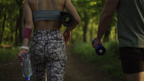 couple exercising outdoors in forest