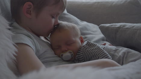 newborn baby asleep in big brothers arms, family first concept
