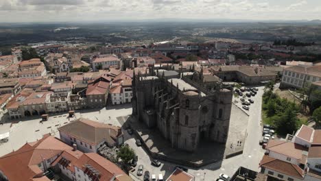 establishing shot of castle like cathedral in guarda portuguese tourism location, panoramic drone view