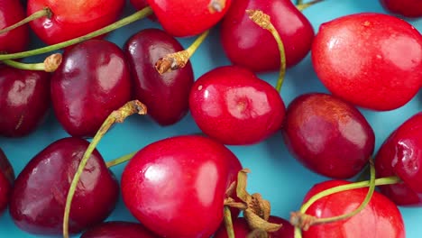 close-up of fresh cherries on a blue surface