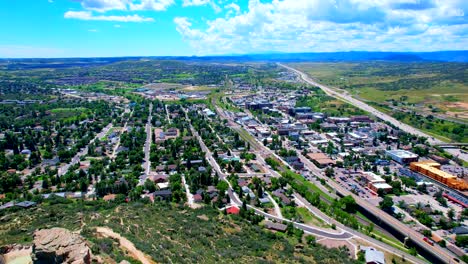 Drone-reversing-over-downtown-Castle-Rock-Colorado-with-Mountains-and-Denver-in-the-background